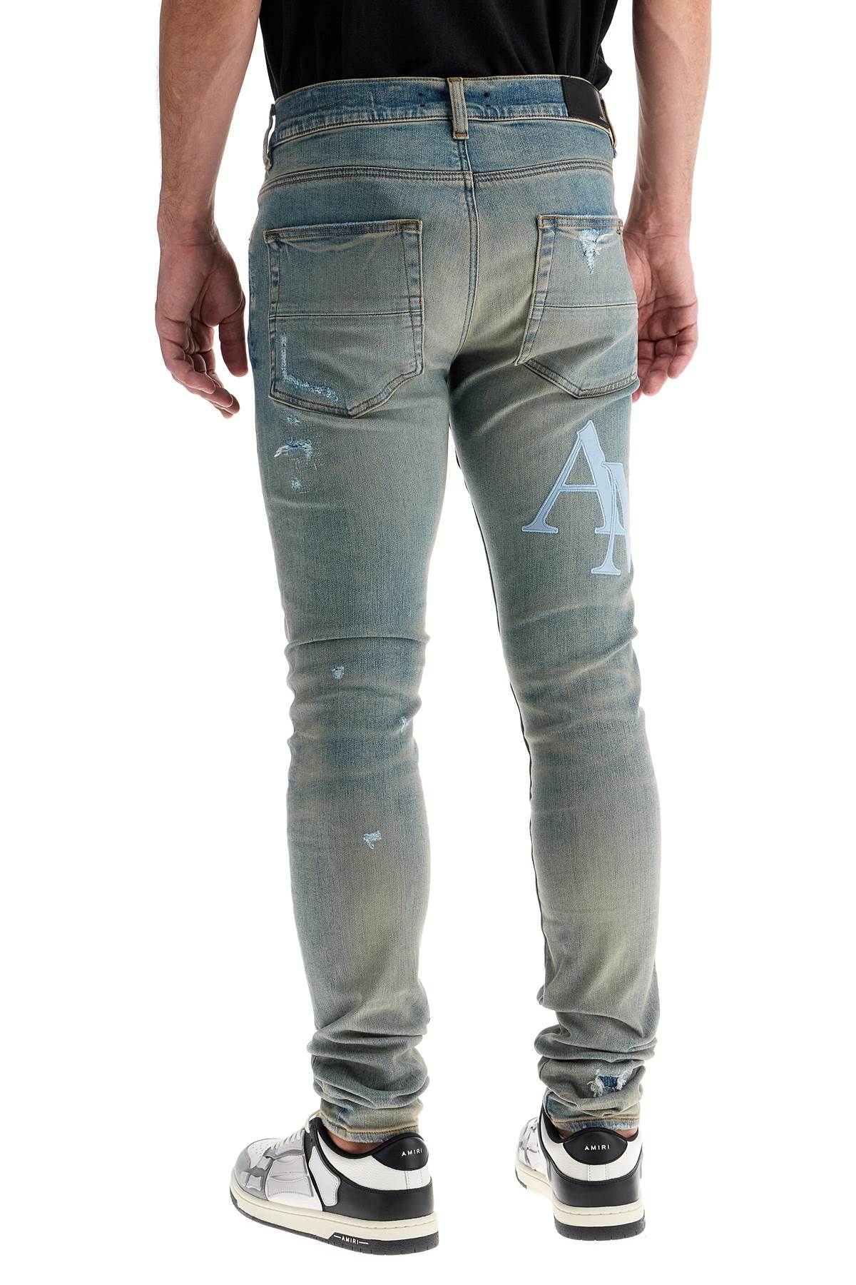 Shop Amiri Leather Logo Jeans With Eight Words In Blue