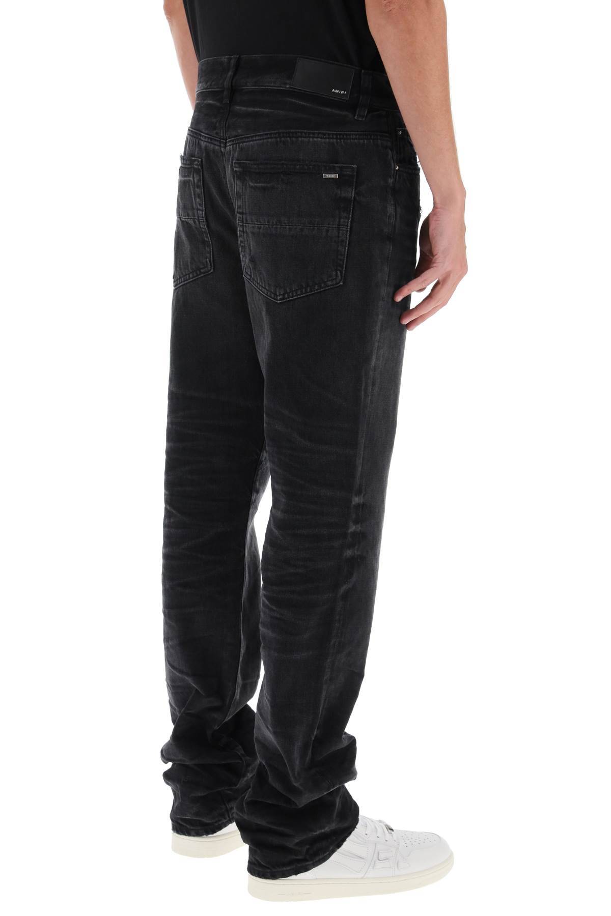 Shop Amiri Straight Cut Jeans In Black