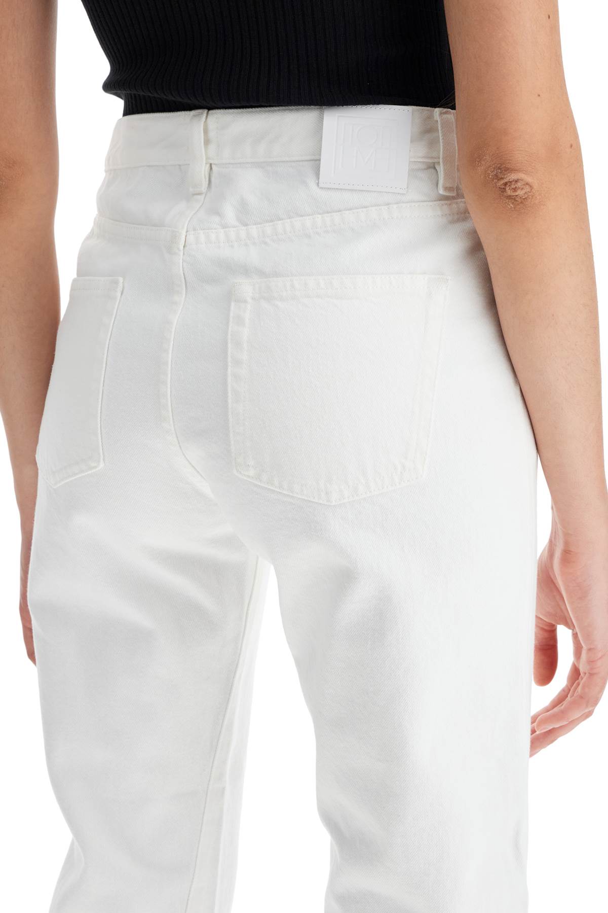 Shop Totême Twisted Seam Cropped Jeans In White