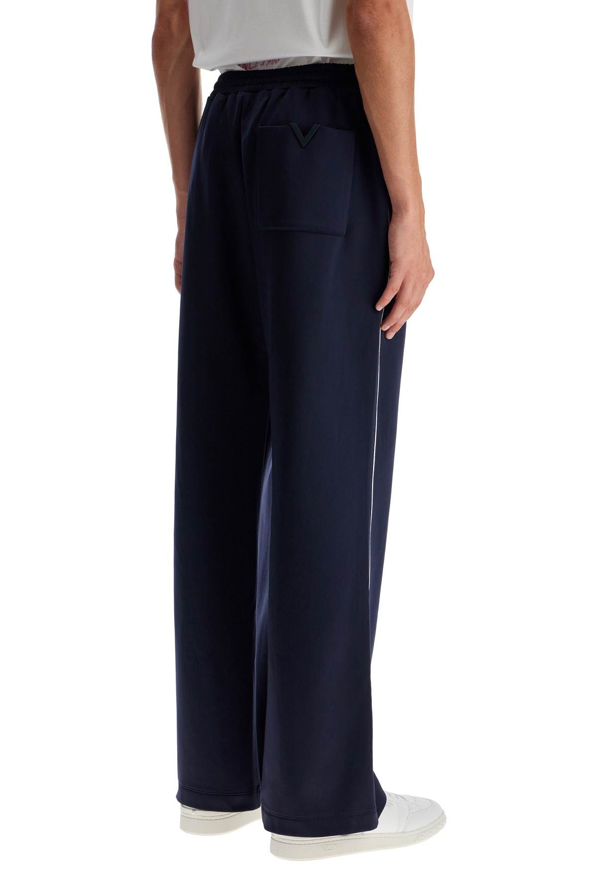 Shop Valentino Jogger Pants With Metallic V Detail In Blue