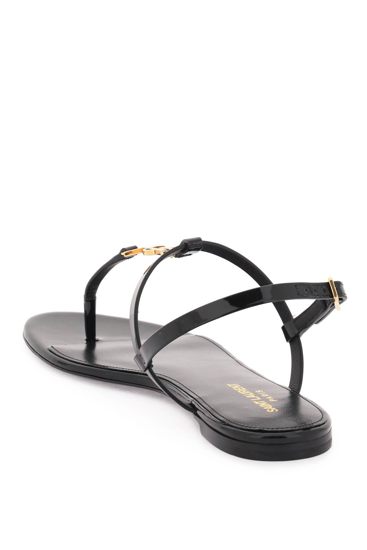 Shop Saint Laurent Patent Leather Cassandra Flat Sandals In Black