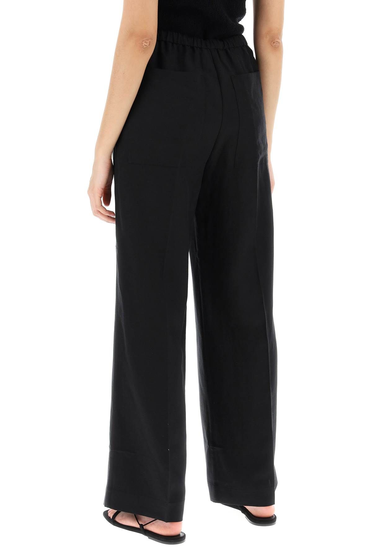 Shop Totême Lightweight Linen And Viscose Trousers In Black